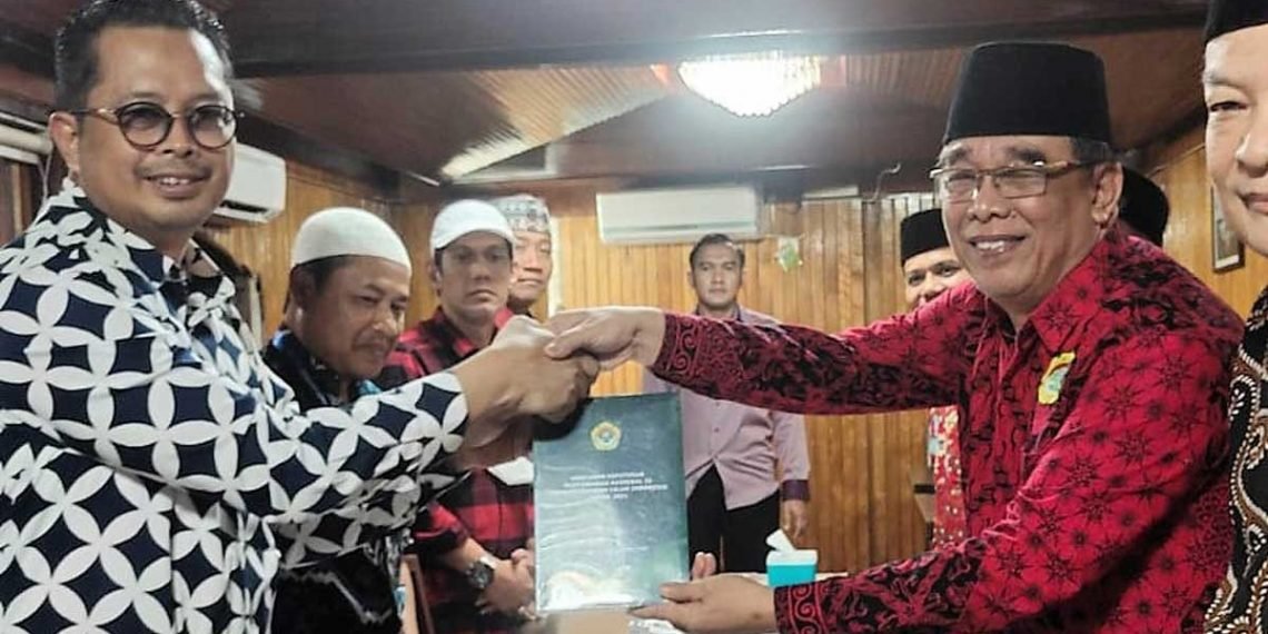 Wakil Ketua DPD RI H. Mahyudin menerima buku hasil Munas LDII 2021 dari Ketua DPD LDII Balikpapan H. Herry Fathamsyah di Rumah Makan Bondy Balikpapan, Selasa (26/7). Foto: LINES